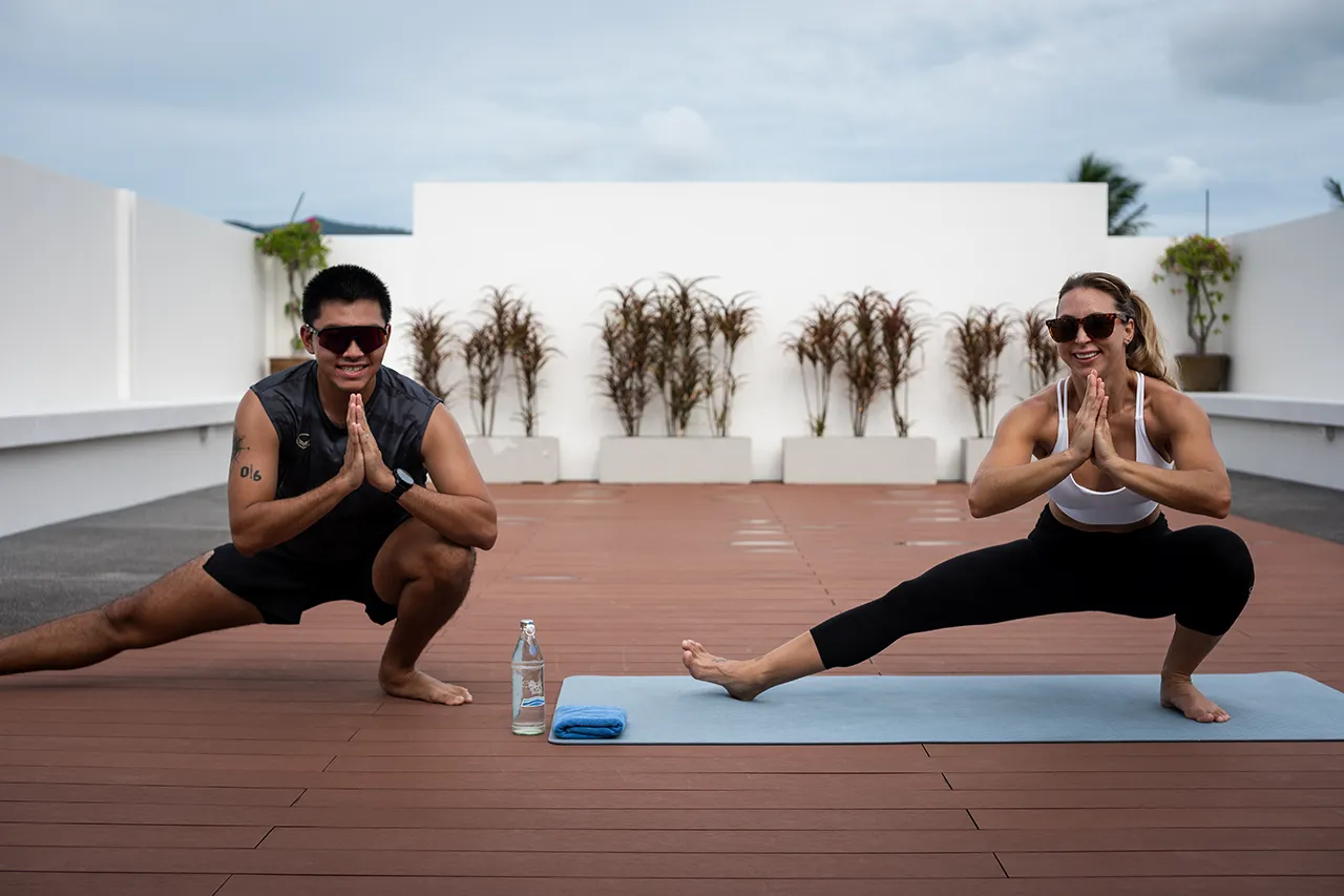 Outdoor yoga session on a rooftop at Exhale Wellness & Spa in Koh Samui, with a view of the surrounding landscape.