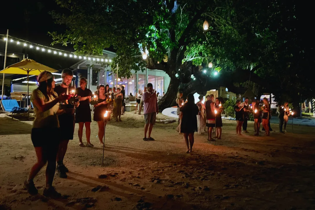 Guests floating krathongs at the beachfront resort Explorar Koh Phangan during the Loy Krathong festival.